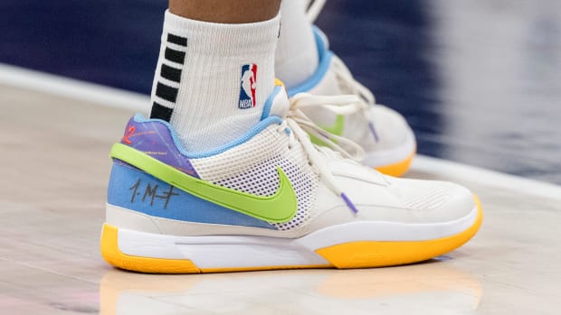 Detroit Pistons forward Tosan Evbuomwan's white and green Nike shoes.